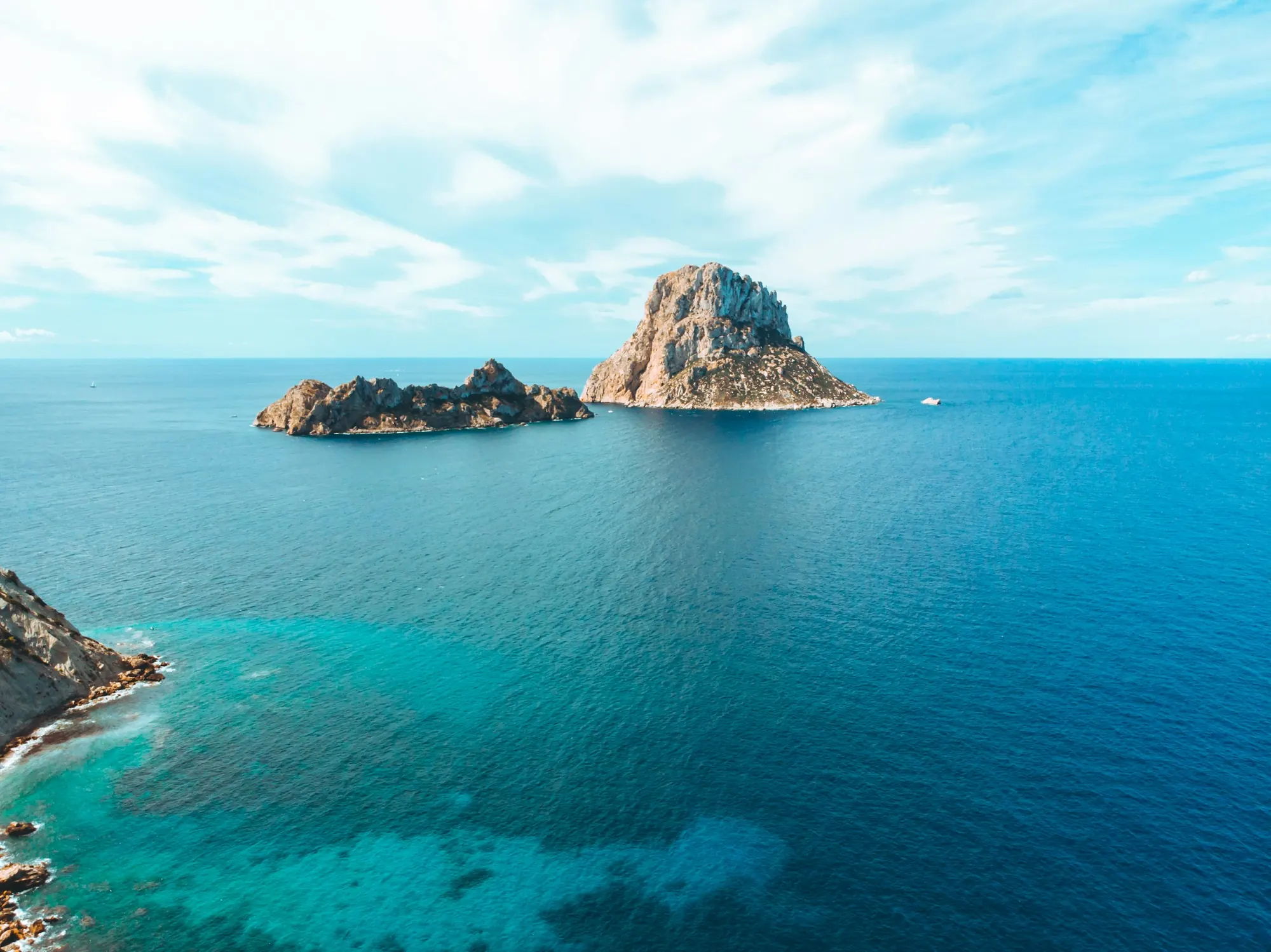 Es Vedra rising from turquoise water off the southwest coast of Ibiza, seen from the air